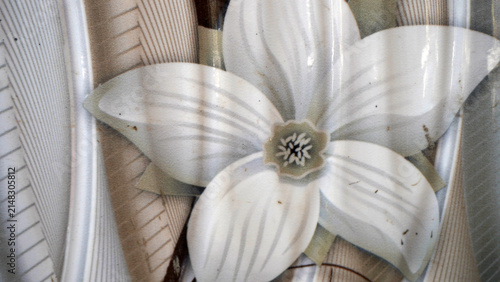 Artificial white flower decoration with striped petals.