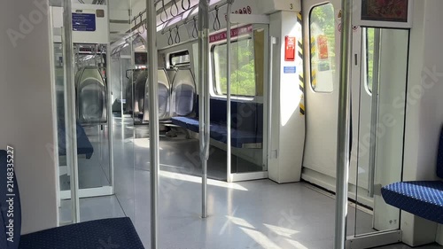 Malaysian KTM Komuter electric train arriving at the station platform, public transportation.