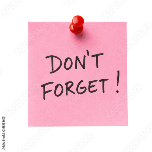 Pink reminder note with don’t forget message and red push pin