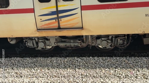 Malaysian KTM Komuter electric train arriving at the station platform, public transportation.