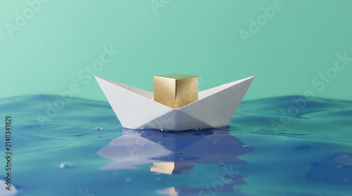Small paper boat with a golden cube cargo floating on blue water against a soft green background
