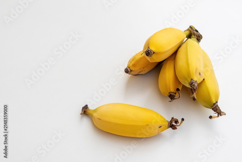 a bunch of small yellow bananas on a white background