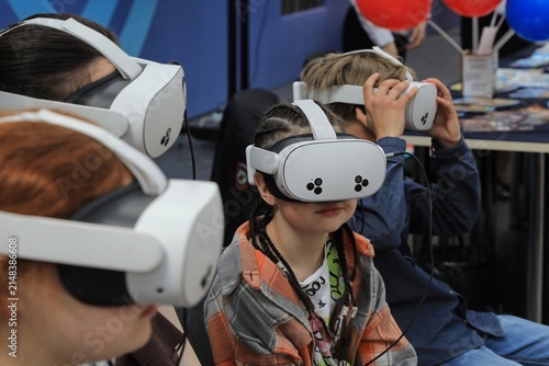 : children are playing computer games using virtual reality glasses