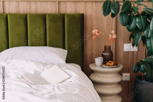 Konstfotografi Open book on bed in a modern bedroom during the weekend morning