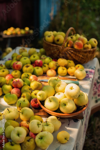 Abundant harvest of fresh apples displayed on a table and in a basket
