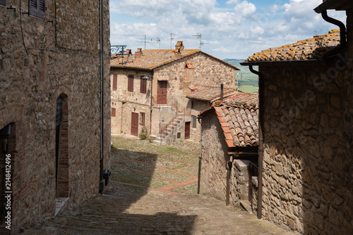 Old stone buildings and cobblestone alley in the medieval village of Castiglione d'Orcia, Tuscany, Italy