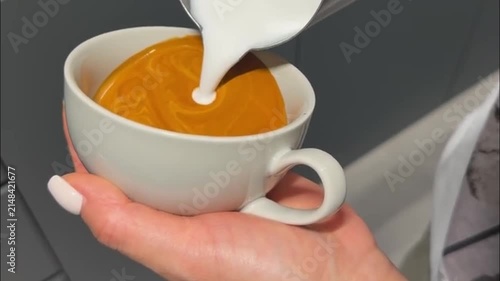 Barista Pouring Steamed Milk to Create Swan Latte Art Design in Coffee Cup
