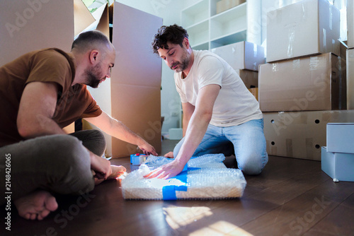Two Men Packing Boxes During Home Moving Day