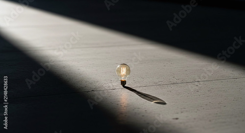 Glowing Light Bulb in Beam of Light Representing Idea and Creativity