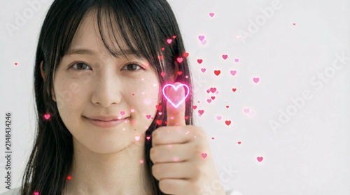 Young Woman Giving Thumbs Up with Hearts and Neon Glow