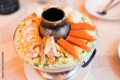 Thai style steamed egg hot pot with fresh seafood served in Thai style stainless steel hot pot