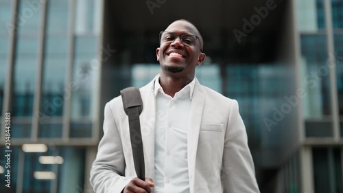 CEO, african american businessman, confident portrait, outdoor near office building. Black business man smiling, works as CEO, building strong client partnerships, leading cross-functional projects.