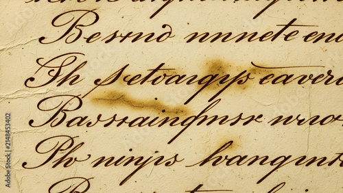 Vintage handwritten calligraphy script ink text on aged paper featuring textured scorched edges and weathered surface