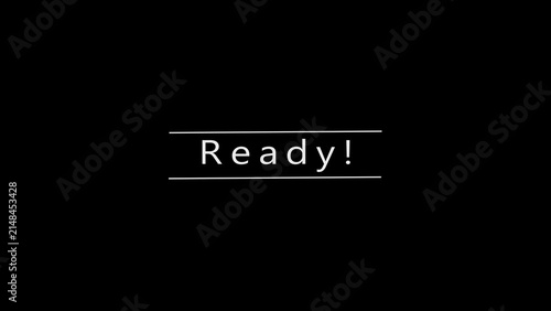 The word Ready is presented in a clean white sans-serif font centered on a solid black background, framed by two thin white horizontal lines, signifying preparedness and availability for action