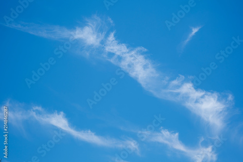 Canvas Print Wispy clouds stretching across clear blue sky background