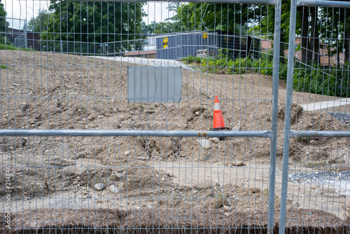 Construction site behind temporary wire mesh security fence