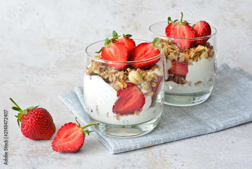 Yogurt Parfaits with Granola and Fresh Strawberries on Napkin copy space front view