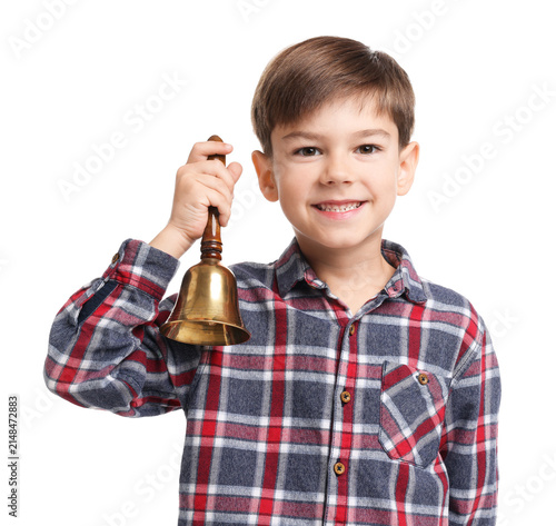 Cute boy ringing school bell on white background