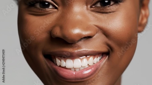 Closeup of a bright white human smile showing healthy teeth and gums, dental care and oral hygiene concept
