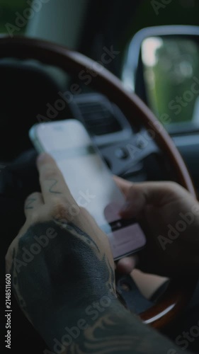 Hands holding a smartphone inside a vehicle, representing automotive e-commerce, car service apps, garage appointments, roadside assistance, vehicle maintenance, and connected mobility. 4K.