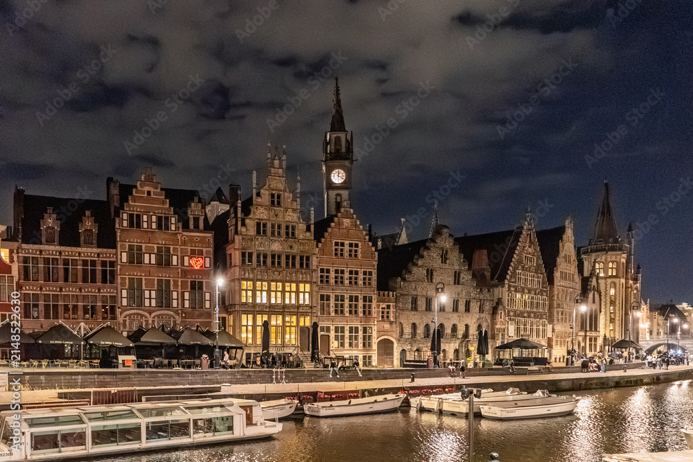 Fototapeta premium Illuminated Historic Guildhalls and Canal View at Night in Ghent, Belgium