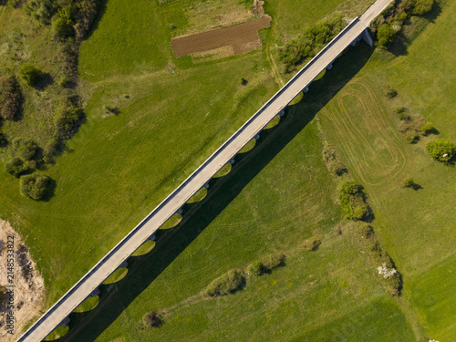Aerial view of Tsar's Bridge spanning across the green fields in the countryside in Niksic, Opstina Niksic, Montenegro.