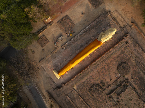Aerial view of Wat Lokaya Sutha with its reclining Buddha statue draped in a saffron robe amidst ancient brick ruins in Phra Nakhon Si Ayutthaya District, Phra Nakhon Si Ayutth, Thailand.