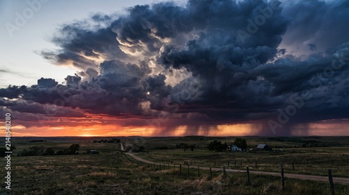 Dramatic Storm Clouds Over Rural Landscape at Sunset.