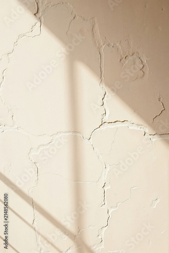Minimalist aesthetic background of cracked beige concrete wall