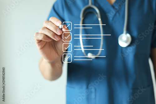 Obraz na plátně close up young general practitioner hand use stylus pen to check box on medical