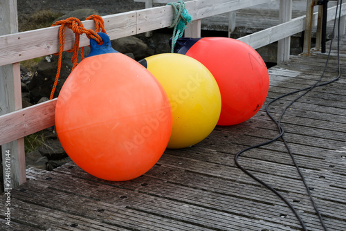 Colorful Marine Buoys on a Wooden Pier
