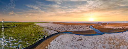 Canvastavla Aerial view captures coastal salt flats and winding river
