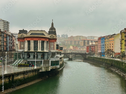 Bilbao, Spain - 24 December 2025: View of the Mercado de la Ribera along the Nervion River in Bilbao, Basque Country, Spain.