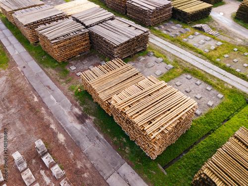 Aerial view of stacked timber logs in a lumber yard, representing sustainable construction and mass timber resources in Brankas, Jelgava Municipality, Latvia.