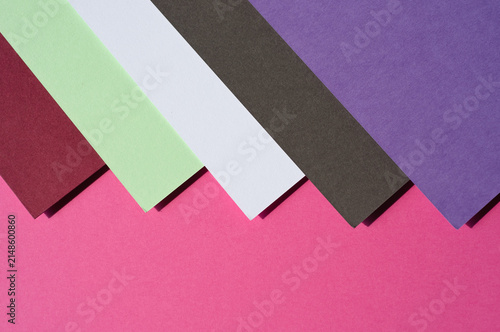 Colored paper, flat cardboard. Stacks of paper sheets of varying thicknesses and colors.