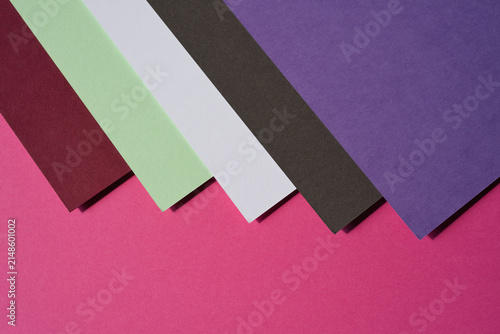 Colored paper, flat cardboard. Stacks of paper sheets of varying thicknesses and colors.