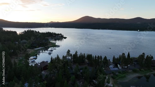 A Drone flight over Big Bear and the Marina showing the recreational areas and the lake at sunset 

