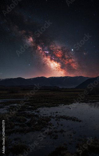 Night landscape, Milky Way  galaxy on the sky over the lake and mountains.