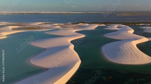 Aerial view of white sand dunes and turquoise lagoons in Parque Nacional dos Lencois Maranhenses, MA, Brazil.