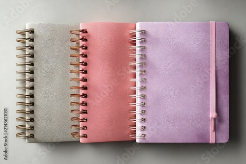 Minimalist arrangement of three notepads