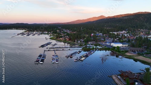 A Drone flight over Big Bear and the Marina showing the recreational areas and the lake at sunset 

