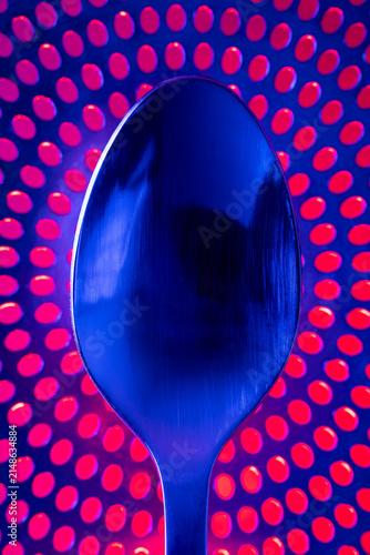 Spoon On Drain Cover - A blue and red abstract.
