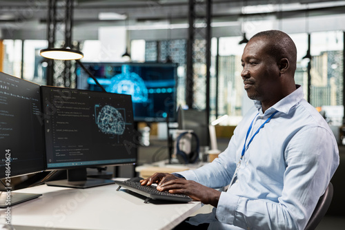 Obraz na plátně System administrator uses AI scripts on a computer to automate repetitive tasks, applying artificial intelligence technology to accelerate feature implementation and improve productivity in an office