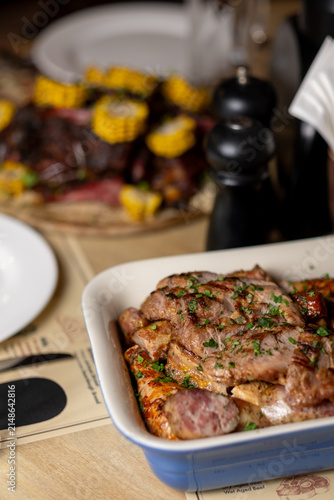 Assorted grilled meats served in restaurant with barbecue platter