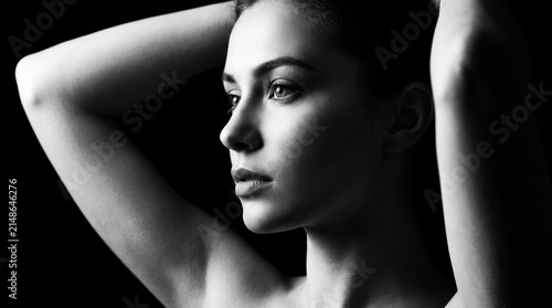 Portrait of a beautiful young woman with expressive eyes in black and white.
