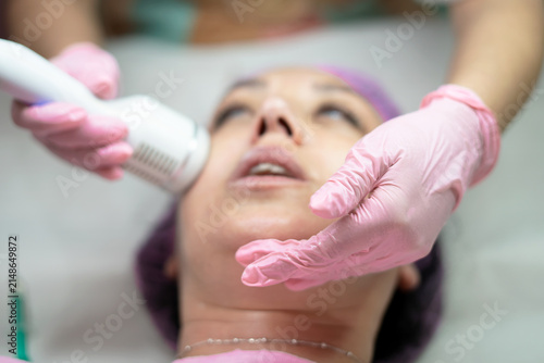 Fotografie Woman receiving facial skin tightening treatment in clinic