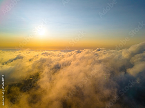 Aerial view of golden clouds at sunset above the landscape in Vidzeme, Latvia.