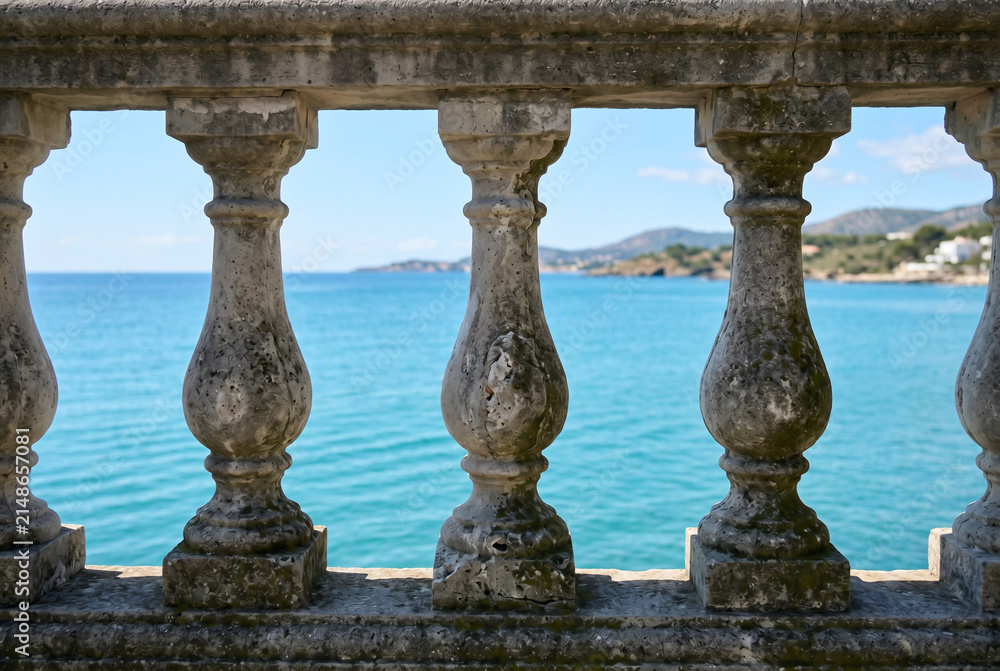 Fototapeta premium Old weathered concrete balustrade overlooking a calm turquoise sea
