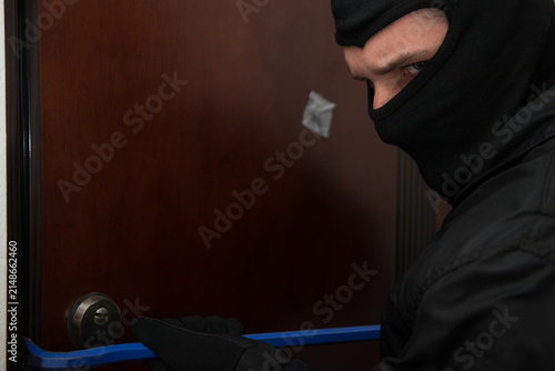 Принти на полотні Male Burglar In Mask Breaking Into The House