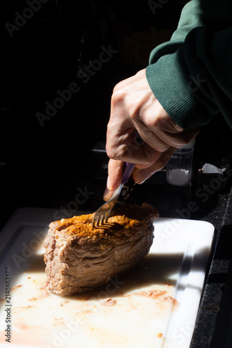Hand Holding Fork Over Cooked Cupim Beef Roast